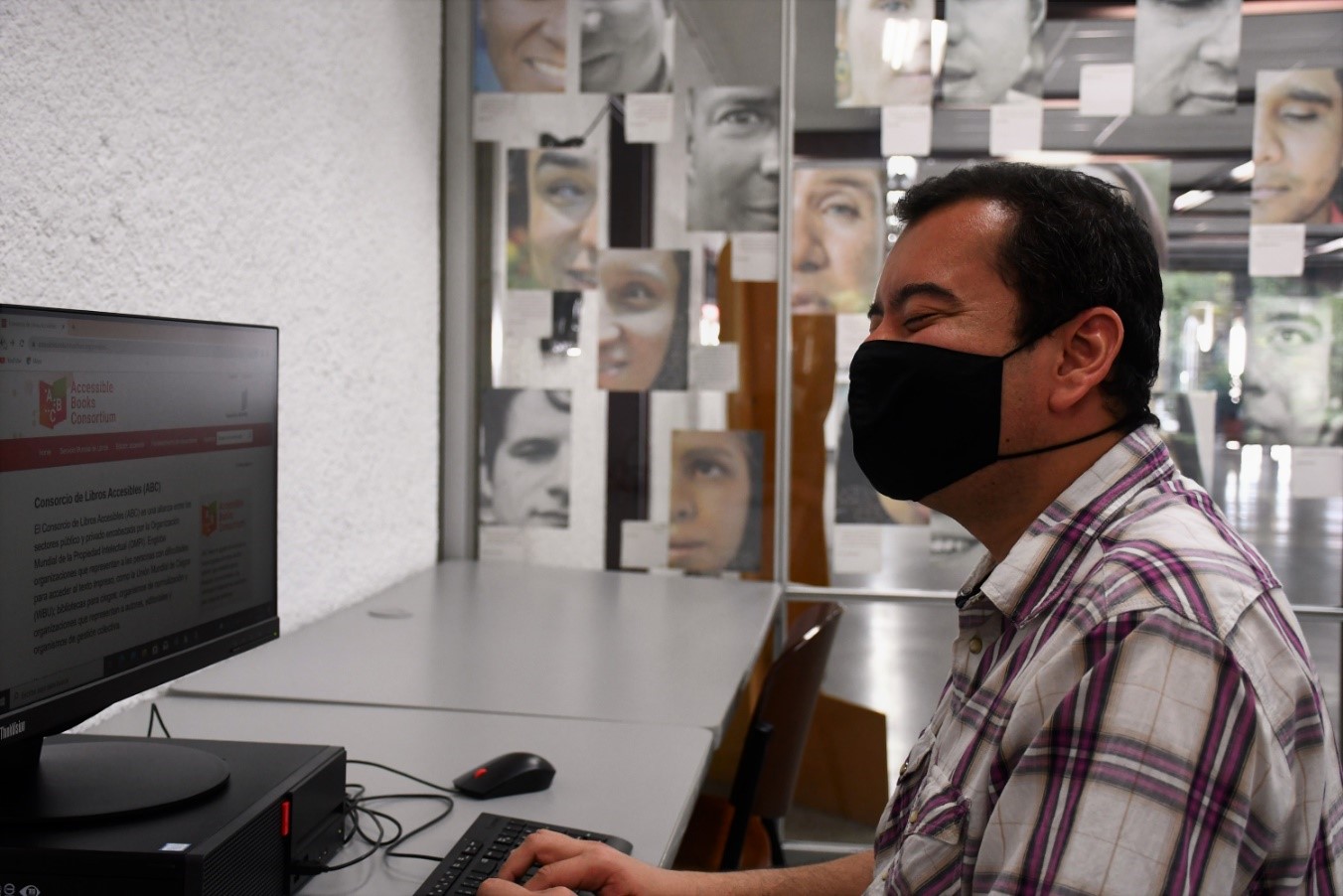 A person wearing a headset and sitting at a desk

Description automatically generated with low confidence