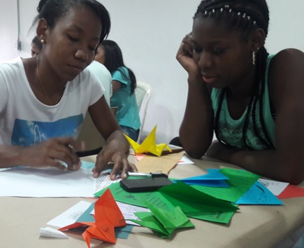 dos estudiantes haciendo origami.