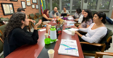 Tres íconos de siluetas de personas y una mano señalando al ícono de la mitad.